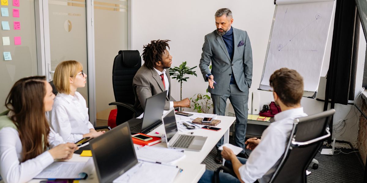 An upbeat small business team collaborating together in a sleek modern office.