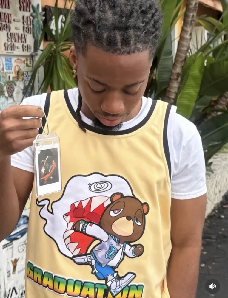A customer wearing a custom Frame Wave tag with a music photo