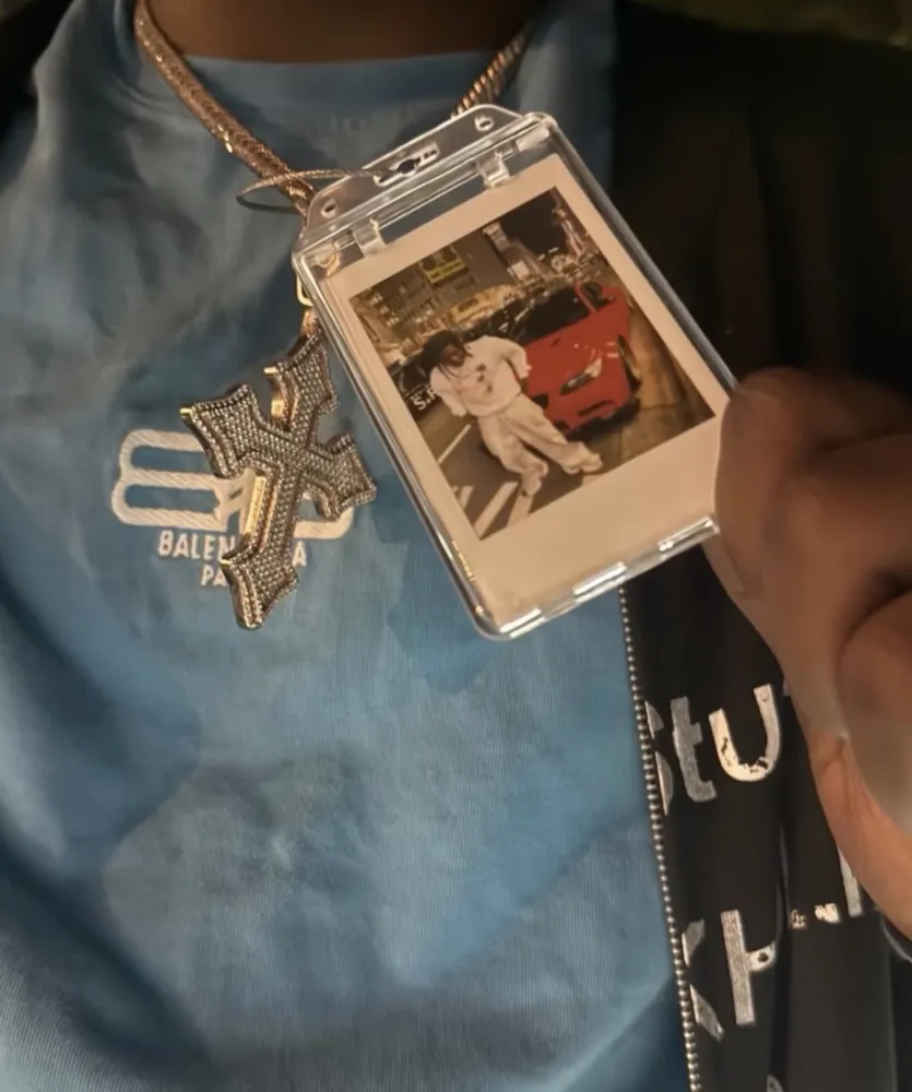 A Frame Wave tag worn on a chain with a custom photo insert